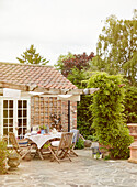 Outdoor furniture and trellis on exterior patio of Northumbrian home England UK