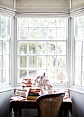 Horse's head and vintage books on desk in bay window of County Durham home England UK