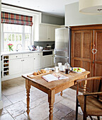 Wooden chair at table in kitchen of County Durham home England UK