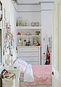 Souvenirs and mementos surround pink quilted bed in Country Durham home, North East England