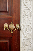 Gilt door handle and decorative plasterwork in Capheaton Hall, Northumberland, UK