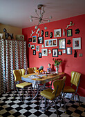 Yellow leather table and chairs with black and white floor and picture wall in County Durham home, North East England, UK