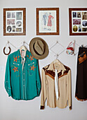 Cowboy shirts and hat with framed family photograph in County Durham home, North East England, UK