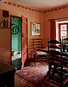 Hues of orange and wooden furniture Herefordshire farmhouse dining room, UK