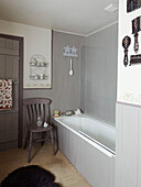 Grey bathroom with coir matting in Herefordshire farmhouse, UK
