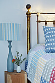 Striped lamp and patchwork quilt in Worcestershire bedroom, England, UK