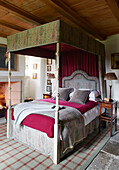 Grey and pink blankets on four postered bed Scottish castle, UK