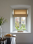 Roman blinds at window in kitchen of Woodstock home, Oxfordshire, UK