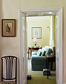 View through doorway to turquoise sofa in Syresham home, Northamptonshire, UK