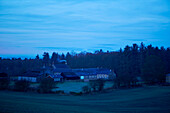 Bauernhaus und Waldgebiet in der Abenddämmerung in Northumberland, UK