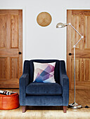 Blue armchair and desk lamp in Durham home, England, UK