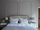 Muted lilac and beige in panelled bedroom of Durham home, England, UK