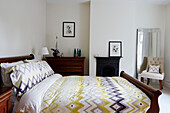 Purple and yellow patterned duvet in bedroom of Durham home, England, UK