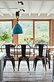 Vintage metal chairs at table with view of Devon countryside, UK