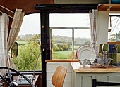 View outside the drivers window beside the kitchen sink inside The Majestic bus near Hay-on-Wye, Wales, UK