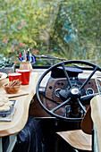 Kitchen worktop beside the steering wheel inside The Majestic bus near Hay-on-Wye, Wales, UK