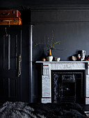 Marble fireplace and built in wardrobe with black paintwork in Ramsgate bedroom Kent, UK