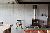 Wood burning stove and chair in open plan living room of Sligo home, Ireland
