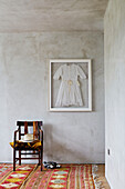 Framed confirmation dress with belts and hat on chair in Sligo home, Ireland