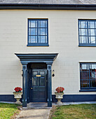Blue painted porch and windowframes of Devon home, UK