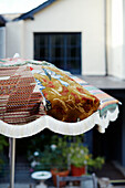 Handmade fabric parasol in garden of Devon home, UK