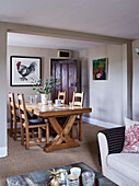 Wooden dining table and chairs in Devon home, UK