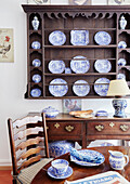 Display of blue and white chinaware with wooden furniture in Foix, Ariege, France