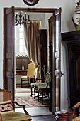 View through double doors with antique furniture in Foix townhouse Ariege, France