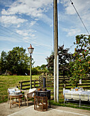 Stove and fireguard with tables and chairs around telegraph pole in North Yorkshire, UK