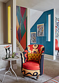 Upholstered tub chair in brightly decorated London apartment, UK