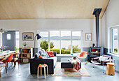 Grey sofa with orange cushions and picture window in open plan Sligo newbuild Ireland