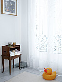 Bathroom with large window and voile curtain