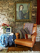 Sitting room with leather chair and Stonework walls