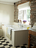 Bathroom with exposed stonework walls