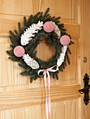 Contemporary floral wreath on wooden front door, Poland