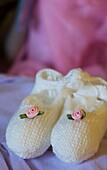 Close up of baby booties with roses