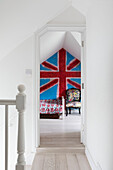 View through landing doorway to bright Union Jack in boy's room of Guildford home Surrey UK