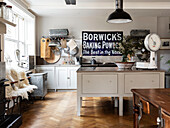 Vintage sign and kitchenware with original parquet flooring in Woodbridge kitchen, Suffolk, UK