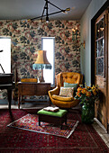 A cosy reading corner by the window in the music room mixing vintage pieces with statement lighting and layered soft furnishings to create a bold unique look