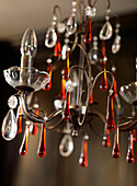 Detail of hanging chandelier light with coloured glass droplets