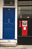 Blue front door with red postbox on Hastings street