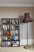 Bookshelf storage and standard lamp in Hastings beach house England UK