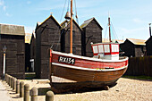 Fishing boat and boat houses in Hastings Old Town England UK