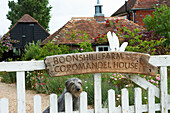 Signpost on gate to farmhouse in Iden, Rye, East Sussex, UK