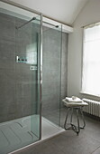 Glass walk-in shower cubicle in tiled wet room of Broadstairs home, Kent, England, UK