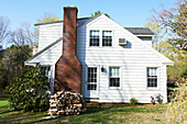 Firewood stacked under brick chimney of detached home in the Berkshires, Massachusetts, Connecticut, USA