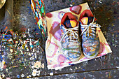 Pair of shoes with paint on floor in Sheffield print studio, Berkshire County, Massachusetts, United States