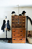 Black blouse on tailors dummy with wooden storage drawers in Hastings cottage, East Sussex, England, UK
