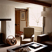 Dunkles gemütliches modernes Wohnzimmer im Landhausstil mit Kamin und Sessel