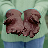 Woman wearing leather gardening gloves